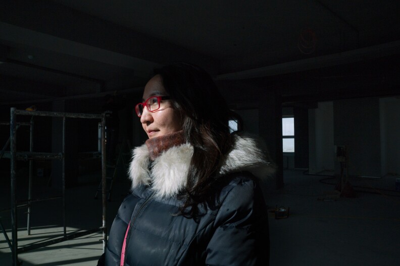 Boloroo Naranbaatar, 43, argues that air quality will improve when quality of life improves in the <em>ger</em> district. She is overseeing a government-led project to expand infrastructure and central services in the most polluted neighborhoods.