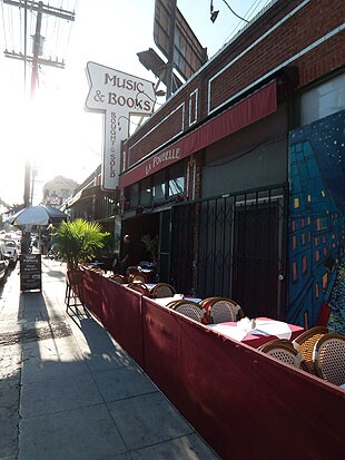 Front sidewalk of La Poubelle restaurant with empty tables