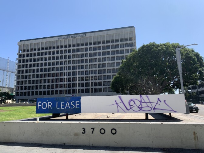 Purple graffiti covers a "for lease" sign outside a building on Wilshire Avenue in Koreatown.