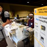 A woman uses hand sanitizer, required by all on entry to the LA County Arboretum Botanic Garden voting center which opened over the weekend on October 26, 2020 in Arcadia, California. - A surge of early voting for the 2020 US Elections suggests this election could have the highest voter turnout in over a century. (Photo by Frederic J. BROWN / AFP) (Photo by FREDERIC J. BROWN/AFP via Getty Images)