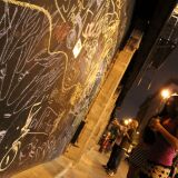 A downtown wall displays words of protest written in chalk.