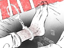 An illustration mostly in black and white shows a person's foot handcuffed to bed rails, with a red background behind the rails.