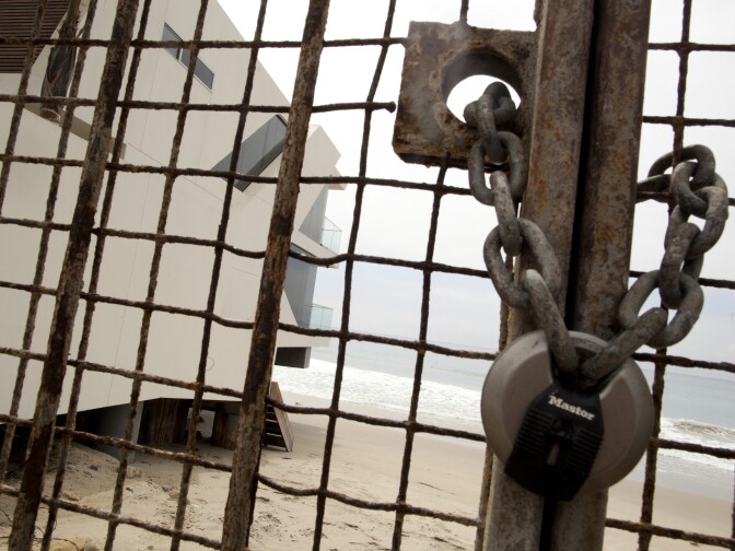 A locked gate at 21660 Pacific Coast Highway blocks beach access in Malibu. For years coastal advocates have been pushing the California Coastal Commission to crack down on homeowners erecting landscaping, fences and fake "no parking" signs to limit beach access to the public.
