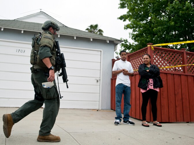 A Sheriff's deputy walks down 17th Street on Friday hours after a series of shootings throughout the city ended at Santa Monica College.