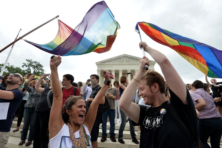 People celebrate outside the Supreme Court in Washington, DC on June 26, 2015 after its historic decision on gay marriage. The US Supreme Court ruled Friday that gay marriage is a nationwide right, a landmark decision in one of the most keenly awaited announcements in decades and sparking scenes of jubilation. The nation's highest court, in a narrow 5-4 decision, said the US Constitution requires all states to carry out and recognize marriage between people of the same sex. AFP PHOTO/ MLADEN ANTONOV        (Photo credit should read MLADEN ANTONOV/AFP/Getty Images)