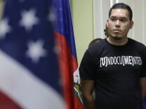 Julio Calderon, 28, an undocumented immigrant from Honduras, listens after speaking in favor of renewing Temporary Protected Status (TPS) for immigrants from Central America and Haiti now living in the United States, during a news conference Monday, Nov. 6, 2017, in Miami.
