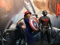 An Agent Carter cosplayer posing with an Ant-Man statue at San Diego Comic-Con 2015.