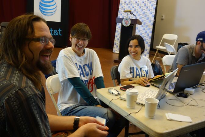 Alric Kaczor, left, Melanie Kaczor and Rachana Kapoor work on an app at the Hack for LA event at Boyle Heights Youth Technology Center. Their app would help people find mentors to help them learn various topics.