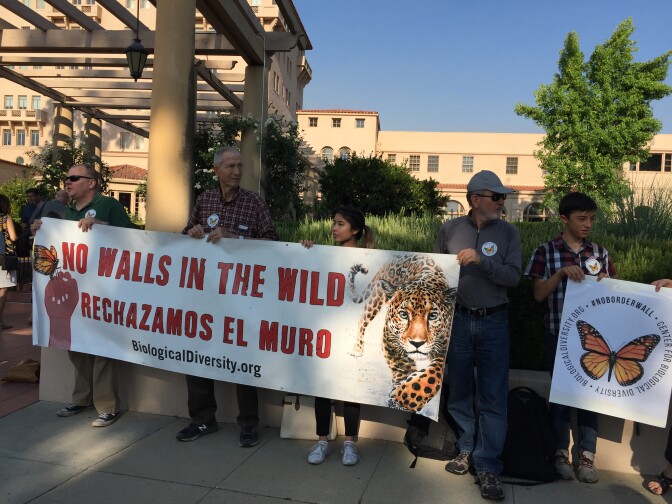 About 20 people gathered in front of the 9th U.S. Circuit Court of Appeals in Pasadena to protest Trump's proposed border wall.