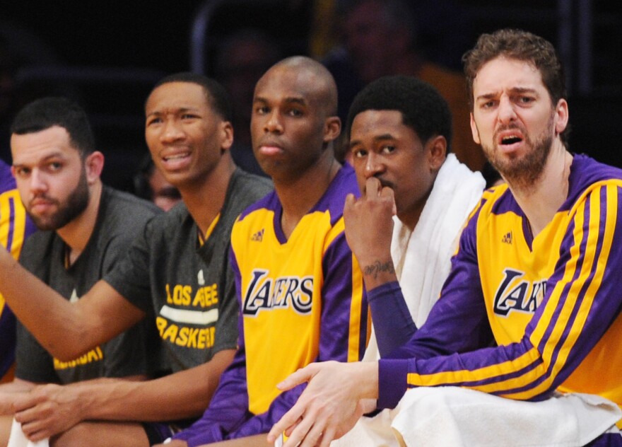 Los Angeles Lakers Pau Gasol (R) sits on the bench with his teammates in the fourth quarter against the Los Angeles Lakers March 6, 2014 at Staples Center in Los Angeles, California. The Clippers defeated the Lakers 142-94.