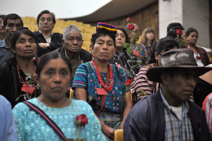Relatives of victims of the slaugther of the villa Dos Erres hold roses on August 2, 2011 in Guatemala City during the trial of military men involved. Four members of military where sentenced to over 6000 years on prison for the murder of 252 farmers in 1982, the killing was one of bloodiest slaughters during the 1960-96 civil war.  