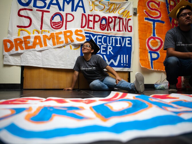 Adrian James, right, and Jahel Campos pass the time on their second day of occupying the lobby in front of Obama's campaign office in Culver City, CA. Though the president announced a plan to defer deportations of undocumented youth, Cabrera and the other protesters feel that this isn't a strong enough action.
