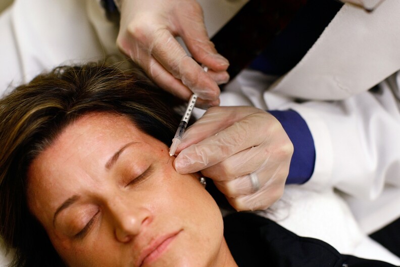 ARLINGTON, VA - JUNE 05:  Recently laid off worker Lyn Talent receives a free Botox injection during an event called the "The Botox Bailout" where the first 50 recently laid-off workers could exchange their resumes for free Botox injections June 5, 2009 in Arlington, Virginia. The event, which took place in a Reveal store, also featured recruiters to help job seekers network, collect resumes and offer on-site interviews.  (Photo by Win McNamee/Getty Images)