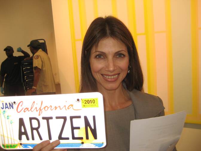 Malissa Feruzzi Shriver, Chair of the California Arts Council holds the California Arts license plate. Sales of the plates have raised more than $20 million for the arts in California 

