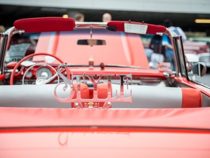 A lowrider displays a chrome plaque for the Style car club.