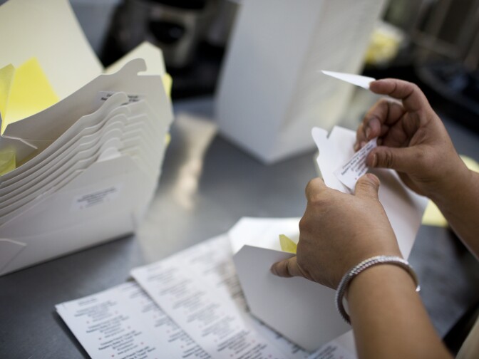 Grub server Sylvia Quintanilla prepares boxes for next day's catering lunch order on Wednesday, June 10, 2015 at Grub's catering kitchen in Hollywood.