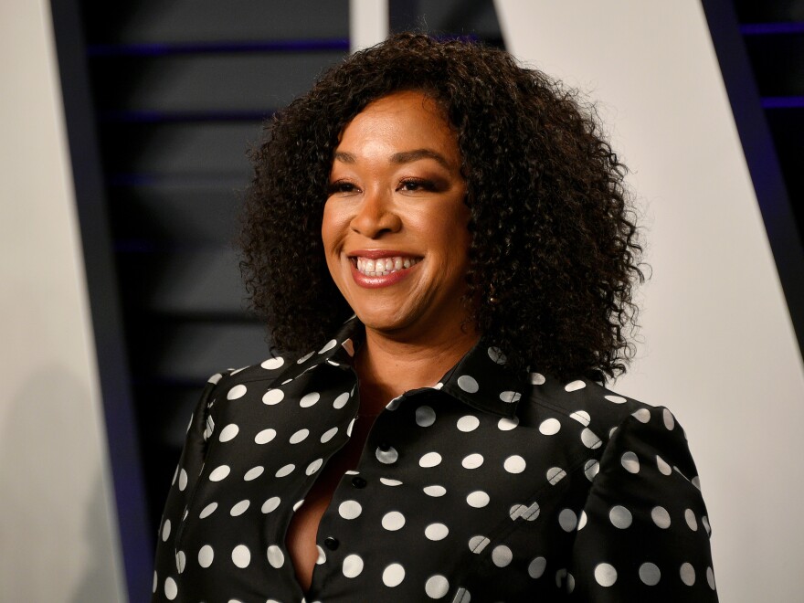 A portrait of Rhimes from the shoulders up while she smiles.