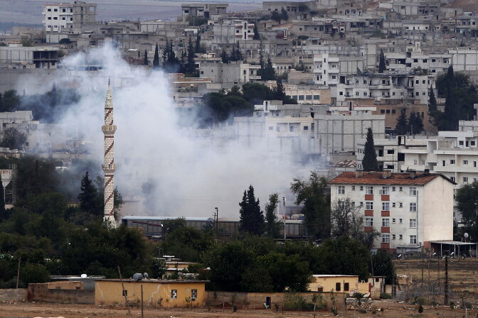 SURUC, TURKEY - OCTOBER 16: (TURKEY-OUT) Smoke billows in Kobani, Syria following an airstrike by the US-led coalition during fighting between Syrian Kurds and the militants of the Islamic State October 16, 2014 as seen from the outskirts of Suruc, Turkey. According to a local official, Islamic State militants have suffered setbacks and have begun retreating from parts of the beseiged Syrian border town of Kobani as Kurdish forces advance against the militant group. Since mid-September, more than 200,000 people from Kobani have fled into Turkey. (Photo by Gokhan Sahin/Getty Images)