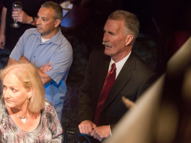 Los Angeles County Sheriff candidate Bob Olmsted watches local television as first results come in at Pierre Garden in Glendale on Tuesday night, June 3.