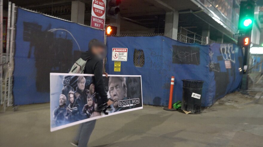 Conservative street artist Sabo preparing to put up a fake bench ad parodying the movie "Rogue One."
