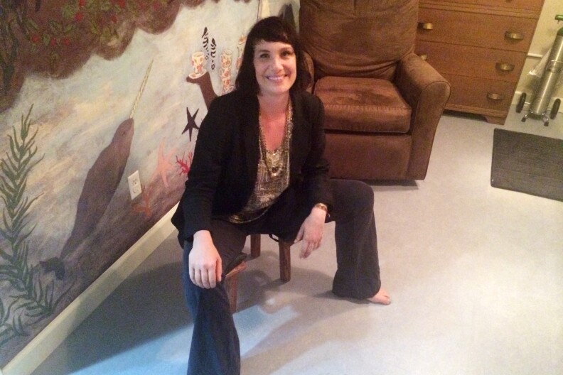 Elizabeth Bachner is a midwife and acupuncturist and owner of GraceFull, a birthing center in Silverlake. She's sitting on a stool that women can use during childbirth.