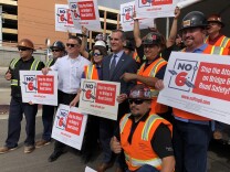 Mayor Eric Garcetti poses with construction workers at a conference where he encouraged voters to vote no on Prop 6 in November.