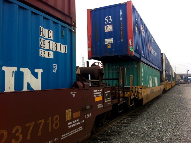 Containers transferred off-dock by truck then take to rail lines. These containers sit atop rail lines in the ICTF. People who live across the street say the fumes and noise are hazardous. 