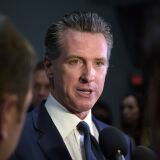 California Governor Gavin Newsom speaks to the press in the spin room after the sixth Democratic primary debate of the 2020 presidential campaign season co-hosted by PBS NewsHour & Politico at Loyola Marymount University in Los Angeles, California on December 19, 2019. (Photo by Agustin PAULLIER / AFP) (Photo by AGUSTIN PAULLIER/AFP via Getty Images)