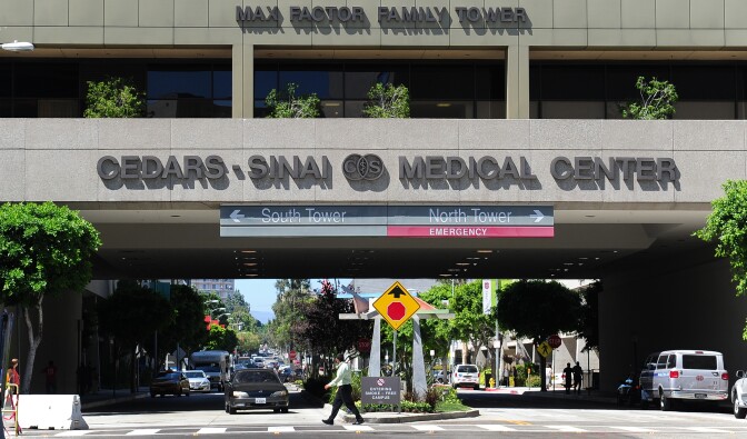 A pedestrain crosses a street at Cedars-Sinai Medical Center in Los Angeles on September 7, 2012 in California.