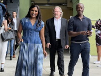 Two people walk toward a camera while touring a school.