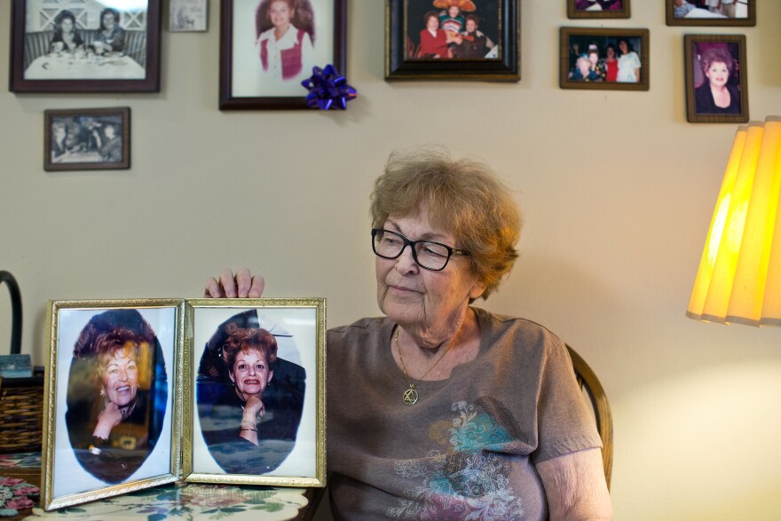 Alice Herman, 78, holds photographs of herself and her partner of 45 years, Sylvia. Herman lives at Triangle Square, an elder care facility in Hollywood mainly for LGBT seniors.
