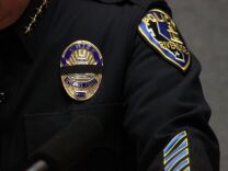 Riverside police officers wear black bands over their badges in honor of RPD officer allegedly gunned down by x-LAPD cop Christopher Dorner. 