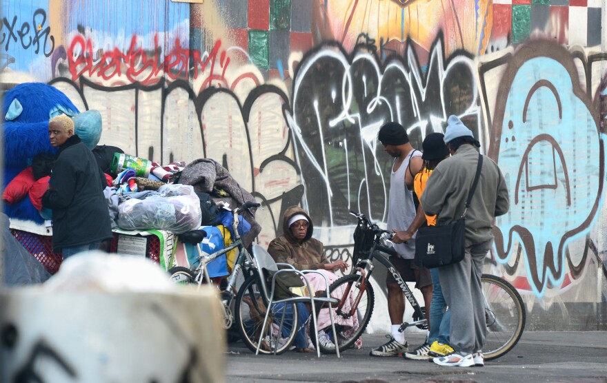A homeless woman sits amid their belongings on a street in downtown Los Angeles, California, on January 8, 2014. Poverty in the world's largest economy remains far from being eradicated fifty years after President Lyndon Johnson declared a war on poverty in America in his first State of the Union address on this date in 1964, with a US Census Bureau report revealing on January 7 that nearly one in three Americans experienced poverty for at least two months during the global recession between 2009 and 2011. And in 2012, poverty affected some 47 million Americans, including 13 million children.