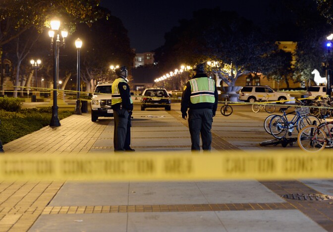 LOS ANGELES, CA - NOVEMBER 01:  USC's Department of Public Safety officer secure the crime scene after four people were shot including one in critical condition during a Halloween party at the Tutor Campus Center on November 1, 2012 in Los Angeles, California. The university issued an alert to students and staff that the police were investigating an incident and requested the campus be shut down while encouraging others to stay away from the area to further notice.  (Photo by Kevork Djansezian/Getty Images)