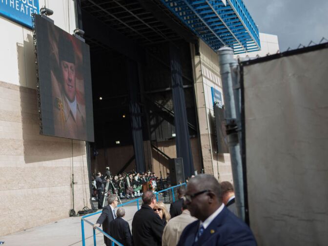 A big screen projects a portrait of Det. Jeremiah MacKay before his funeral in San Bernardino on Feb. 21, 2013.