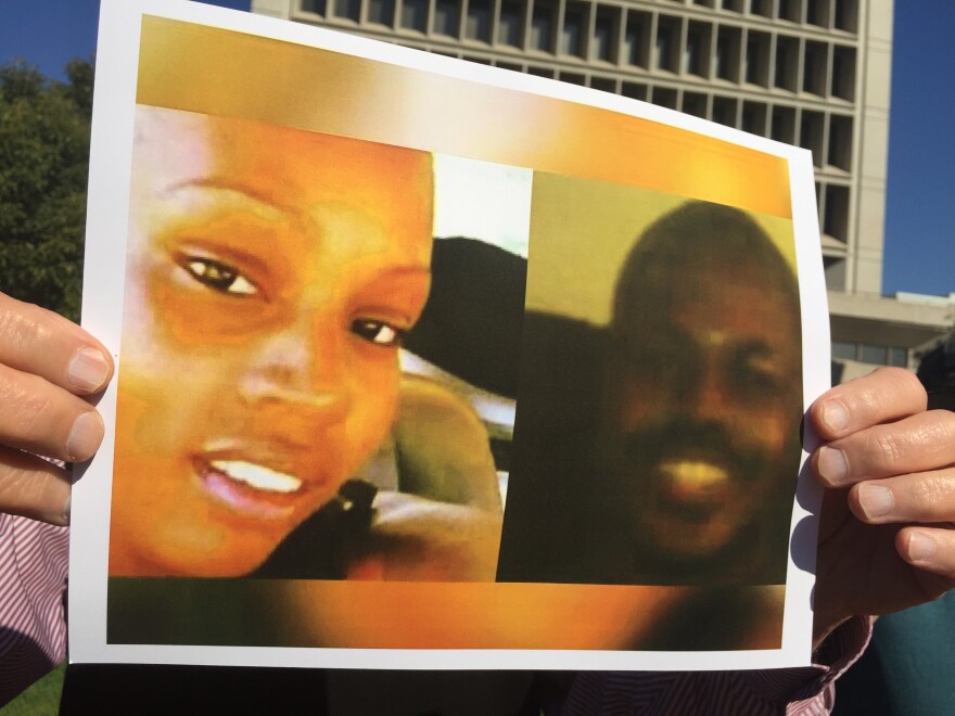 An activist holds up a pictures of Kisha Michael, left, and Marquintan Sandlin. Inglewood Police have yet to explain why they fatally shot the two in February. (11-02-16)