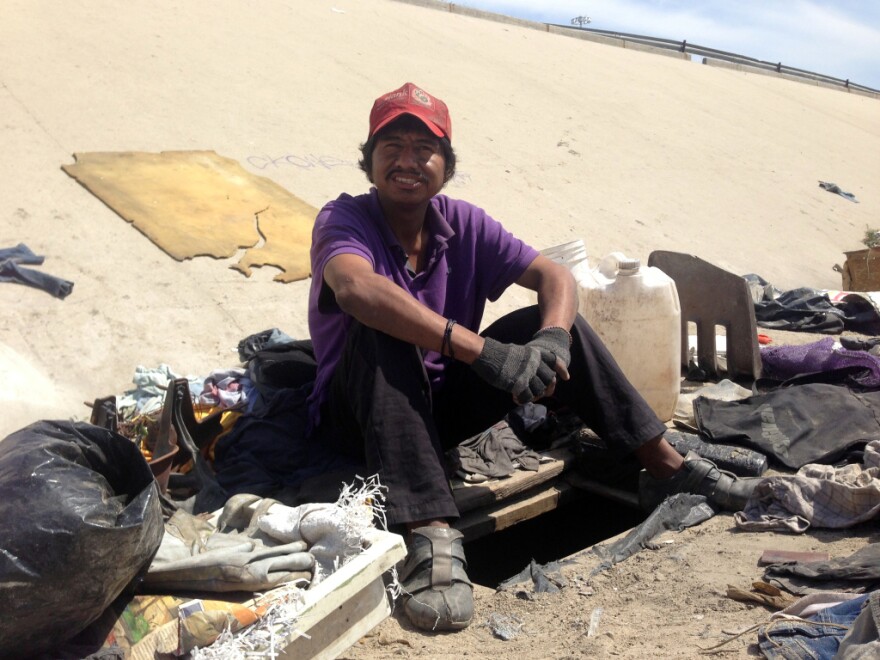 Abimael Martinez, who was deported from Riverside, Calif., with the hole he dug to live in beneath the banks of Tijuana's fetid river canal.