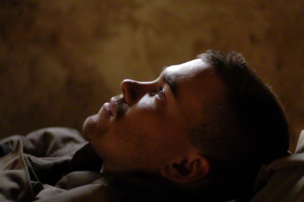 Cpl. Joel Chaverri, a USMC combat cameraman attached to Bravo Company, 1st Battalion, 8th Marine Regiment, takes a break during the battle of Falluja, Iraq on November 13, 2004. (Photo by Ashley Gilbertson / VII Network)
