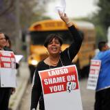 Teachers, parents, supporters and students chant slogans on a picket line outside Crenshaw High School to protest  teacher layoffs planned by the Los Angeles Unified School District (LAUSD)  in Los Angeles, California on May 15, 2009.  California  Governor Arnold Schwarzenegger unveiled yesterday a state budget proposal which called for $9 billion in cuts, of which as much as $5 billion could come from school spending.   AFP PHOTO / ROBYN BECK (Photo credit should read ROBYN BECK/AFP/Getty Images)