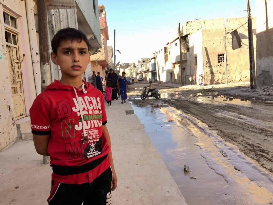 A few families are returning to heavily damaged neighborhoods on the outskirts of Mosul's old city. The residents must be cleared by a committee that certifies they are not ISIS members before they start to move back to repair their homes.