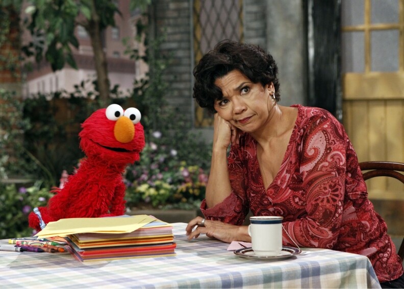 Elmo and Maria, played by actress Sonia Manzano. Manzano has written a memoir called, 'Becoming Maria.'