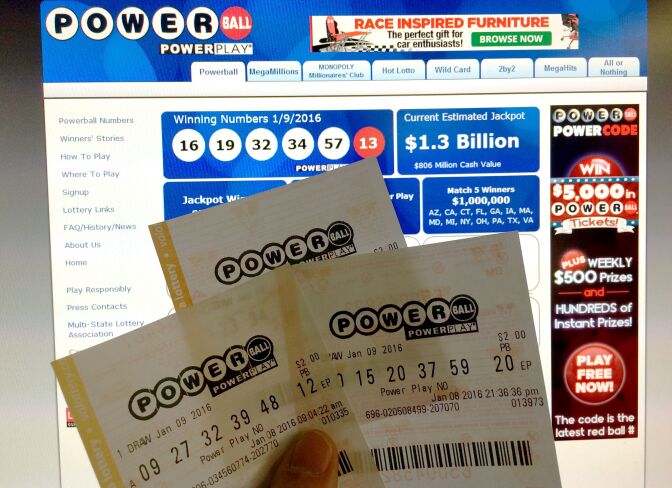 This January 10, 2016 photo illustration taken in Washington, DC, shows Powerball lottery tickets in front of the splash screen for the powerball.com website. The jackpot for the US Powerball lottery rose to a whopping $1.3 billion (1.19 billion euros) on January 10 after organizers said there was no winner in the weekend draw. The Powerball prize rocketed to $950 million on Saturday, fueling a frenzy of lotto ticket buying across the United States.Numbers were drawn and announced late Saturday at 10:59 pm (0359 GMT Sunday) -- but hours later lottery officials said there was no winner.   AFP PHOTO / KAREN BLEIER / AFP / KAREN BLEIER        (Photo credit should read KAREN BLEIER/AFP/Getty Images)