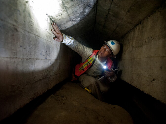 Caltrans Senior Bridge Engineer Bing Wu inspects the underbelly of a bridge that's part of Pacific Coast Highway in Manhattan Beach.