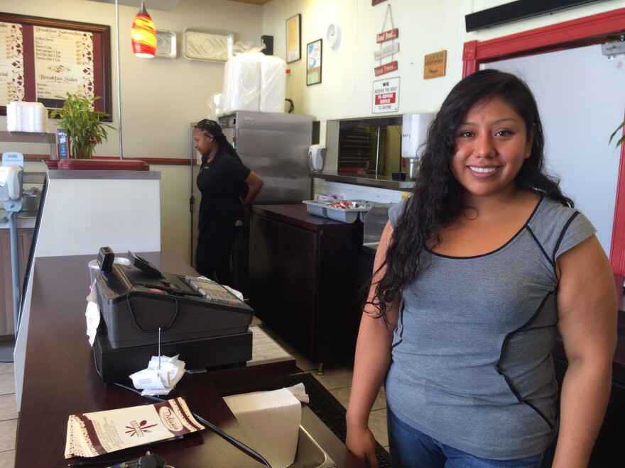 Adriana Cortes is the manager at Delicious Southern Cuisine, on Crenshaw Blvd. Her family opened the restaurant about five years ago and has struggled at times with a chain link fence and other construction directly in front of the store.