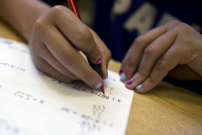 Fire Portegies, 11, is going into sixth grade at the end of this summer. Portegies completes an exercise during the fourth week of a pre-algebra class at the West Angeles Church Youth Center on Thursday afternoon, July 30, 2015.