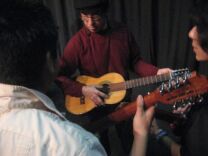 Los Lobos guitarist Louie Perez tunes up with students learning jarana at Frida Kahlo High School.