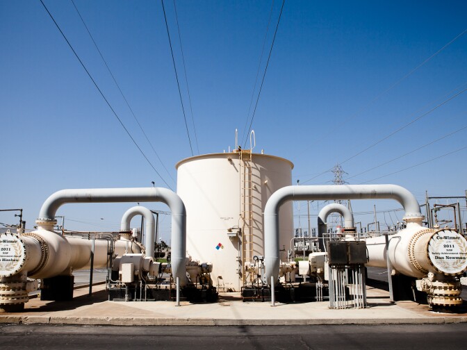 The main transmission lines pass over a holding tank at the AES power plant in Huntington Beach, CA.