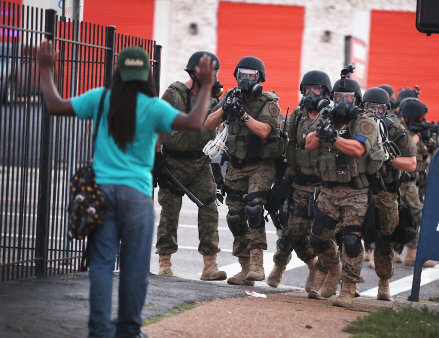 Police force protestors from the business district into nearby neighborhoods on August 11, 2014 in Ferguson, Missouri. Police responded with tear gas and rubber bullets as residents and their supporters protested the shooting by police of an unarmed black teenager named Michael Brown who was killed Saturday in this suburban St. Louis community. Yesterday 32 arrests were made after protests turned into rioting and looting in Ferguson. 