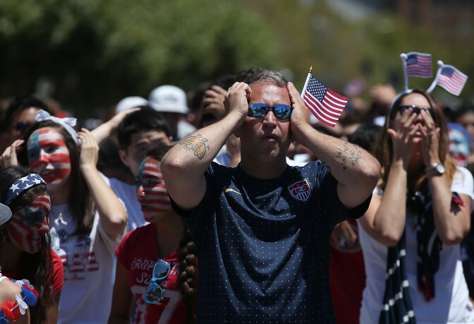 Soccer fans react while watching a live simulcast of the FIFA World Cup quarter final match between USA and Belgium at the Civic Center plaza on July 1, 2014 in San Francisco.