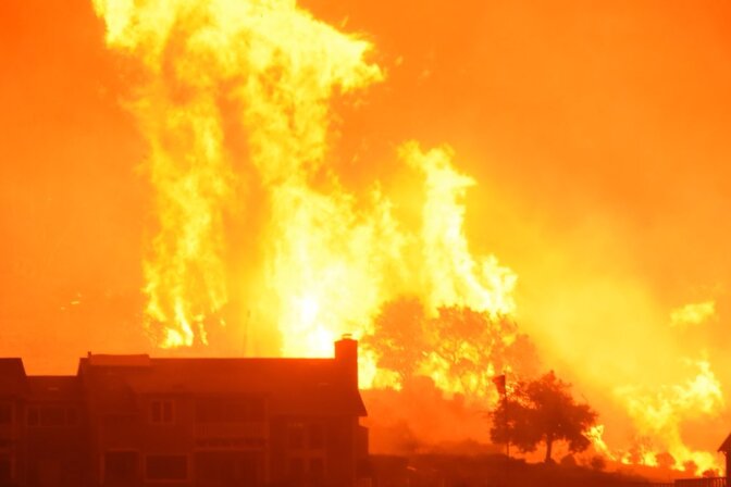 Flames advance on a two story home off Shepard Mesa Road at 5:45 a.m. on Sunday, Dec. 10, 2017 during the Thomas Fire.